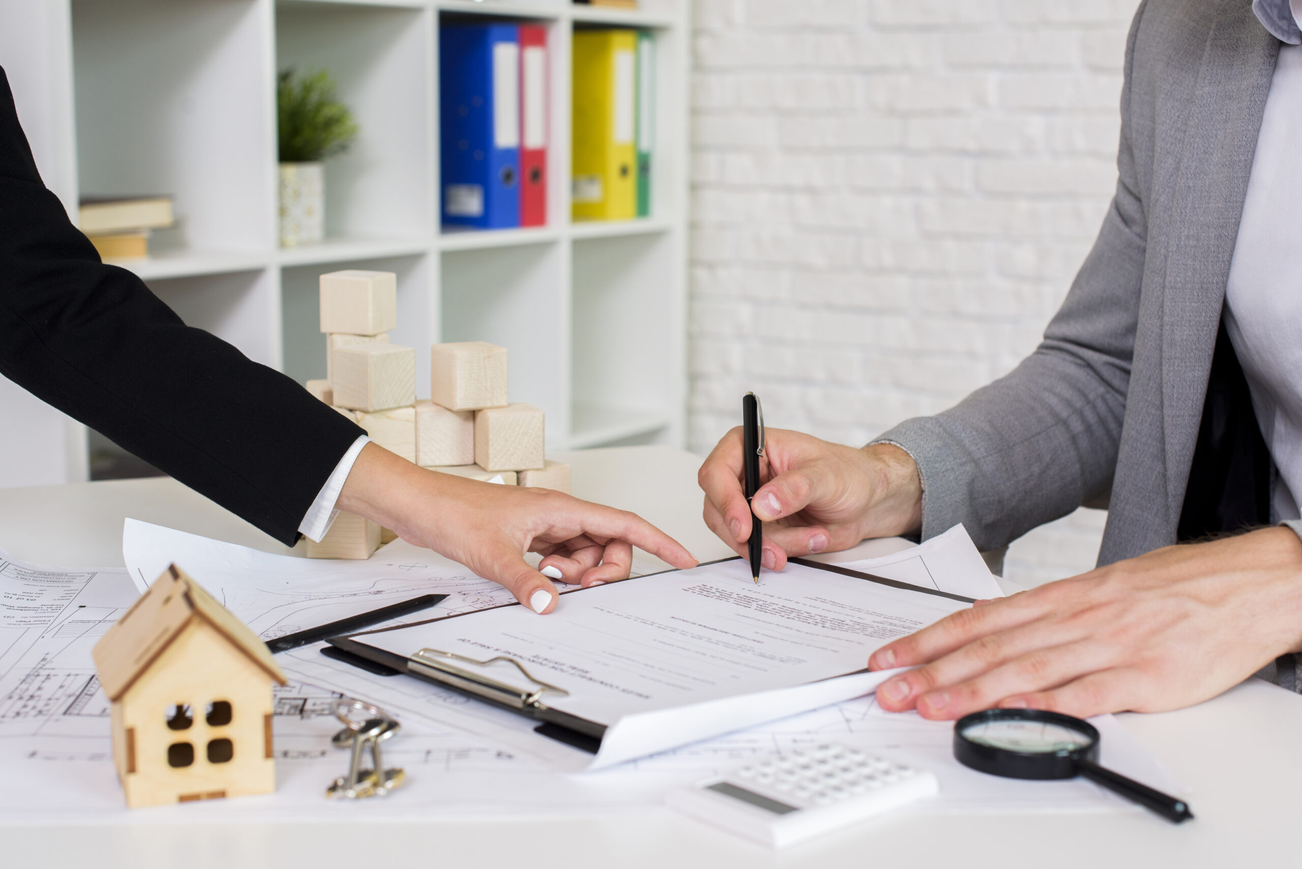 Deal closure moment highlighting legal ownership transfer and successful property transaction